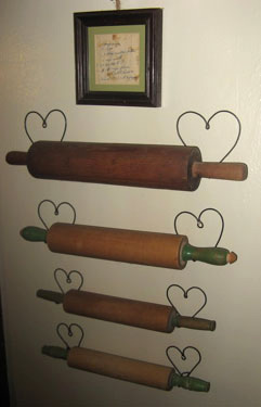Rolling pin hangers proudly display an antique collection.