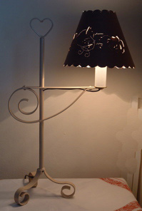 White table lamp with heart topper, scroll body and scroll base.